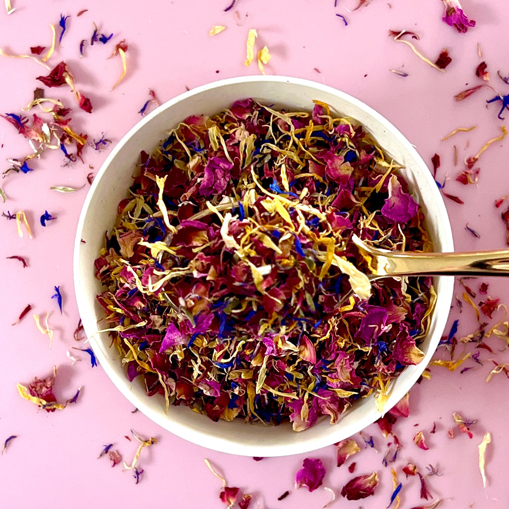 Red and pink rose petals, calendula, blue and pink cornflower, and rosella.